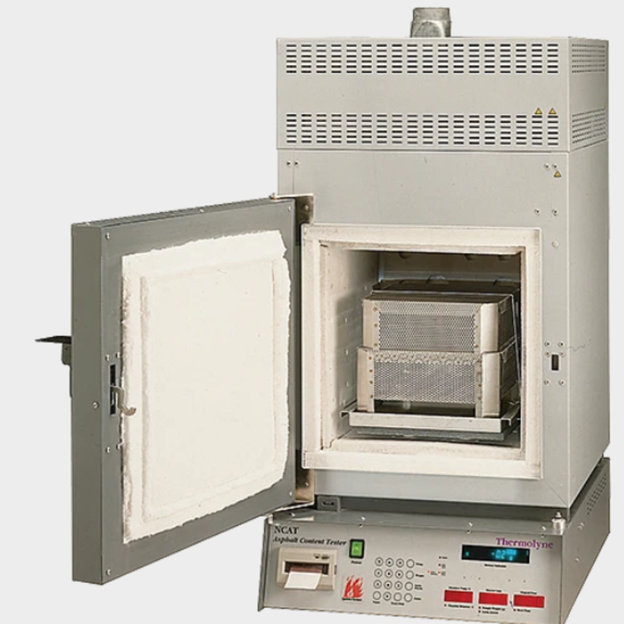 Asphalt Content/Binder Ignition Furnace Supports the following standards: ASTM D6307, AASHTO T308  Key Features:  Asphalt content of bituminous paving mixtures is accurate to 0.11% Accommodates samples up to 5000g Operating Features:  Automatic Mode: endpoint is detected and the software ends the test, prints the results, and beeps until STOP is pressed to unlock the door (in accordance with AMRL specifications) Manual Mode: endpoint is detected and the furnace begins to beep but continues to test until STOP is pressed to unlock the door, then and results print Furnace software automatically compensates for weight change due to sample and basket assembly temperature change Compensation is computed for each sample load tested (i.e, a fixed number is not assigned to a given range of load sizes) Positive or negative correction factors are accepted for use with mixes containing hydrated lime Endpoint within 0.01% of the sample weight is automatically detected Sample stability is reached once the endpoint criterion is met for three consecutive minutes during the test Endpoint sensitivity is adjustable from 0.01% to 0.5% Software computes test results as calibrated asphalt content per total weight of HMA sample or bitumen ratio per weight of dry aggregate 24-hour/7-day timer can be programmed to preheat the furnace RS-232 port provides a data interface with a PC for graphical data analysis Savings and Convenience:  Larger sample testing reduces total samples needed for testing each day, reducing labor and costs Ignition method reduces testing time when compared to solvent extraction: a 1200 to 1800g asphalt sample can be tested in 30 to 45 min. Internal scale monitors sample weight throughout the process, saving technician time and increasing productivity, as samples need not be removed and weighed Standard 30A electrical service is used (50A service costs more to install and operate) Modular design of refractory embedded heating elements provides extended service life and inexpensive, easy replacement Safety:  No exposure to harmful solvents Automatic door-lock prevents door opening during critical test time, protecting the operator and ensuring test integrity High-temperature afterburner is used with a proprietary ceramic filter to reduce ignition process emissions by up to 95% Independent laboratory study, conducted with the California Transportation Department in accordance with California EPA guidelines, showed emissions from the furnace during the ignition test were within EPA parameters A laboratory hygiene study, conducted in accordance with OSHA guidelines, proved the system poses no health threats during proper use Accessory Packages Include:  4 Baskets 2 Trays 2 Covers 1 Handle 1 Cooling cage 1 Insulated plate 1 Pair of gloves 1 Face shield 4 Rolls of printer tape 1 Balance calibration plate 1 Anderol oil CE-approved Note: NCAT Furnaces are not supplied with power cords and must be hard-wired directly to a suitable electrical supply or supplied with a cord and plug by the user.