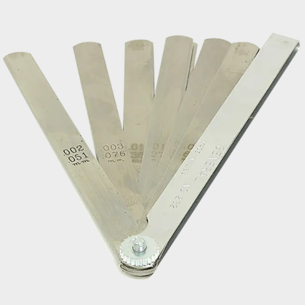 Feeler gauges are used for precise alignment of the base and platen.